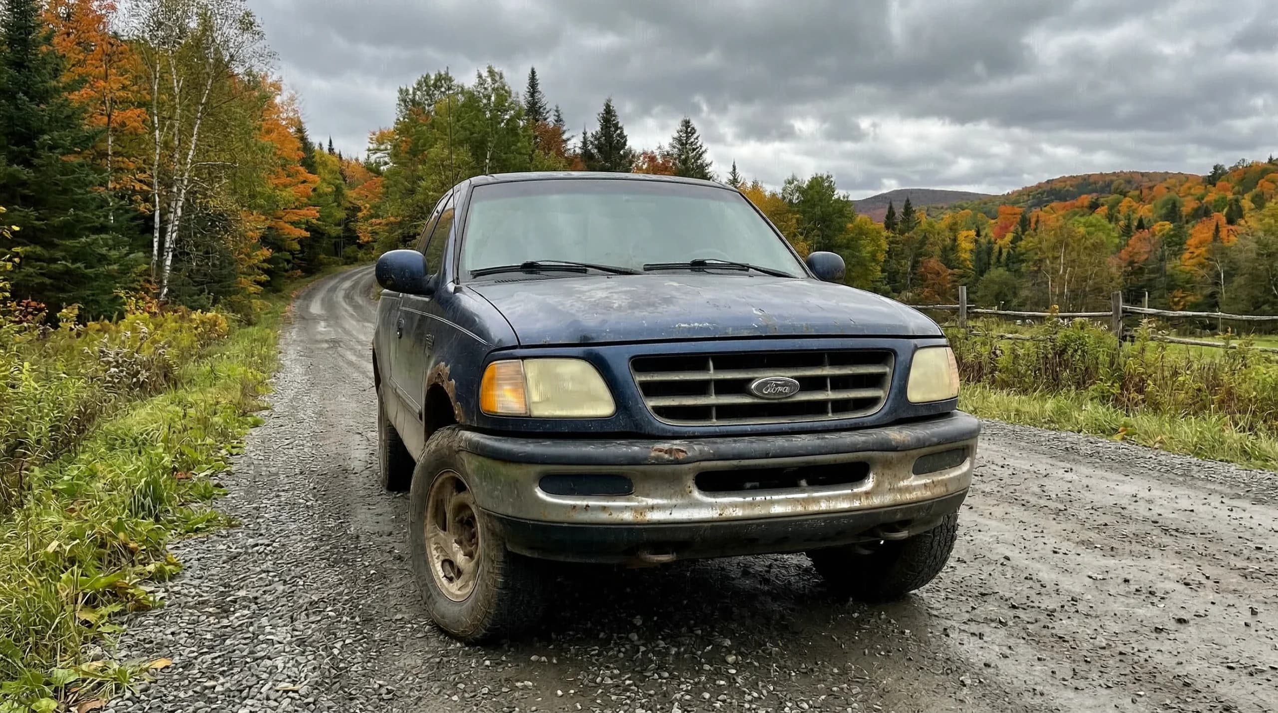 Old pickup truck on a rural autumn road