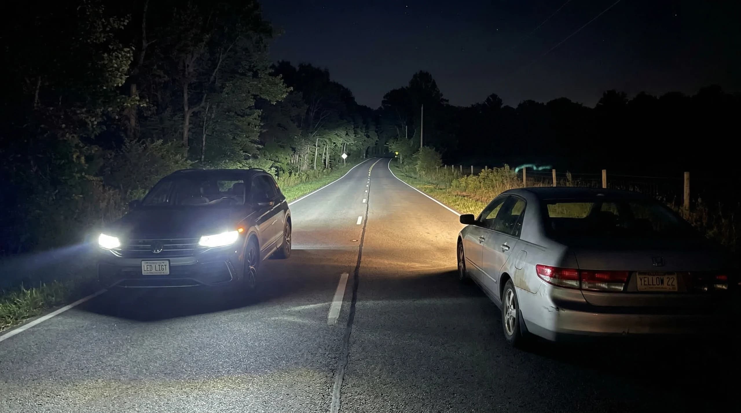 Two cars on a nighttime road.